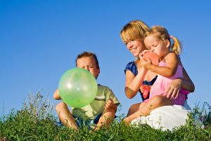 bigstockphoto_Woman_And_Kids_Playing_With_Ba_3476882